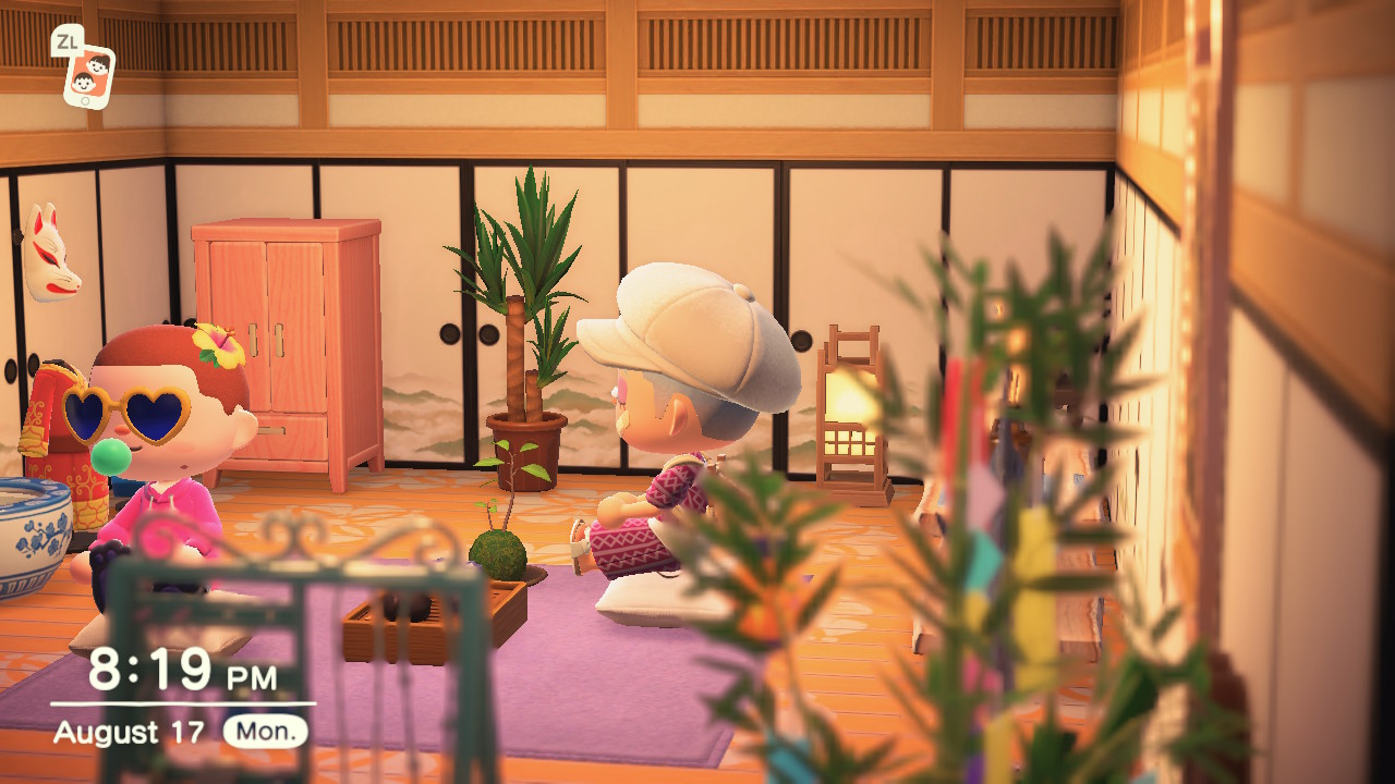 Two players sit in a Japan-esque room.