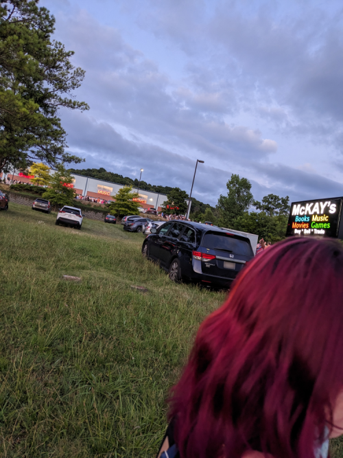 Photo showing the Nashville McKays up a hill and the line in front of it. Cars are parked in the grass below it.